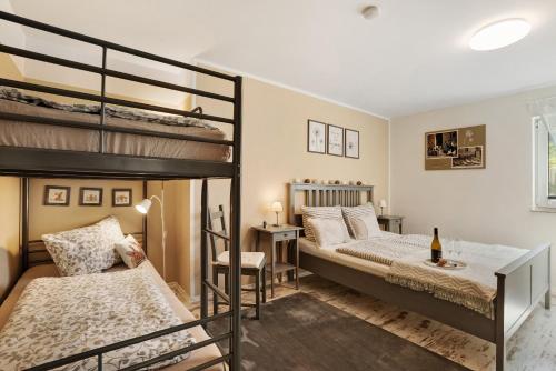 a bedroom with two bunk beds and a desk at Ferienwohnung - Arzgebirg in Grünhainichen
