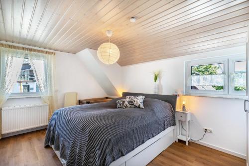 a bedroom with a bed and a wooden ceiling at Ferienwohnug New Look in Geisenheim