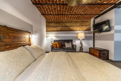 a bedroom with a large bed and a couch at Le Zucche Vuote in Quargnento