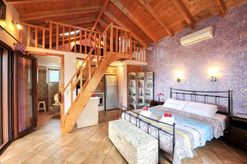 a bedroom with a bed and a wooden ceiling at Villa Casa Bianca Purple Apartment in Gaios