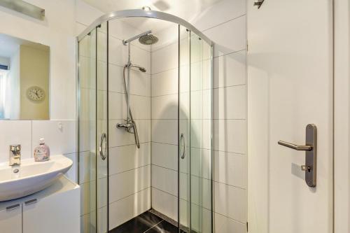 a shower with a glass door next to a sink at Wohnung 1 in Wallhausen