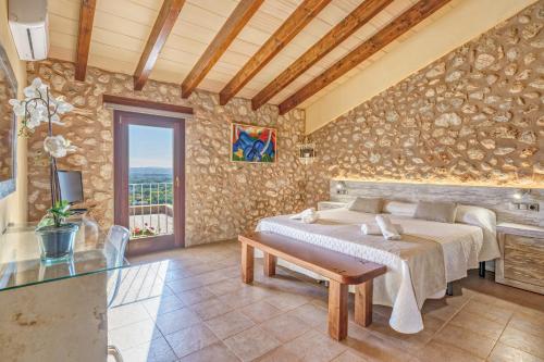 a bedroom with two beds in a room with a table at Casa del Sol in Búger