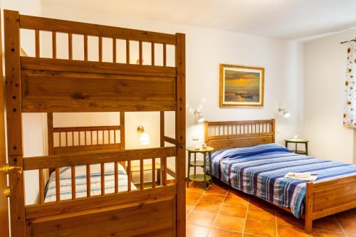 a bedroom with two bunk beds and two tables at Bilo Erica in Marina di Grosseto