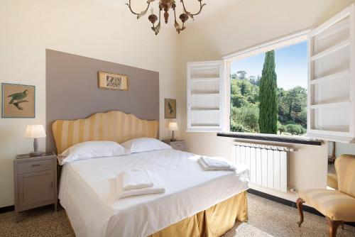 a bedroom with a bed and a large window at Villa Mesco in Levanto