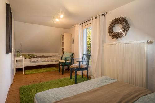 a bedroom with a bed and a table and chairs at Ferienhaus Landlust-Karsee in Wangen im Allgäu