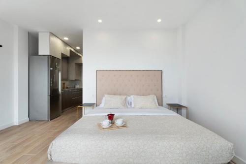 a bedroom with a large bed with two serving dishes on it at Punta del Hidalgo La Laguna in Punta del Hidalgo