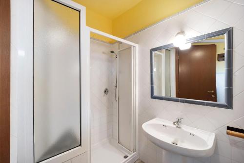a white bathroom with a sink and a shower at Casa Gelsomino in Imperia