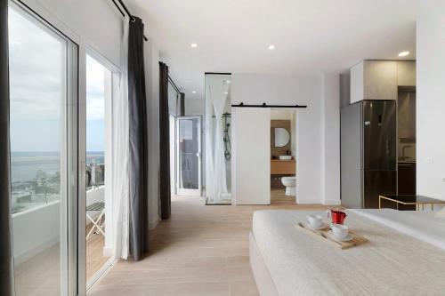 a bedroom with a bed and a view of a bathroom at Punta del Hidalgo La Laguna in Punta del Hidalgo