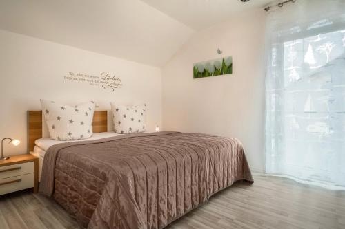 a bedroom with a bed and a large window at Familien-Apartment 1 in Meersburg