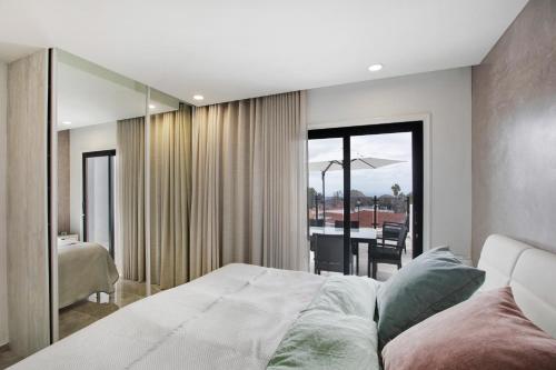 a bedroom with a bed and a view of a patio at Villa La Blanca in Arona