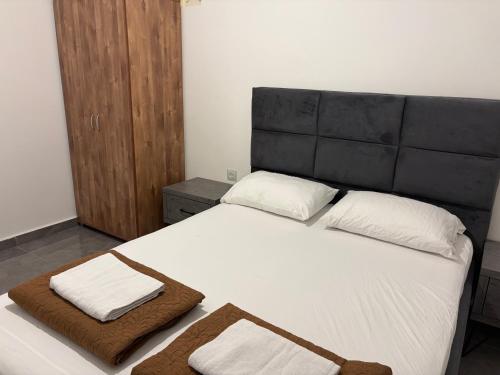 a bedroom with a large bed with two towels on it at Luxury Duplex With Private Pool in Eilat