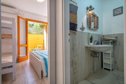 a bathroom with a sink and a bed in a room at Relax Space in Cascabraga