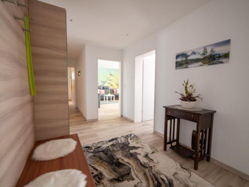 a living room with a table and a mirror at Ferienwohnung Pusteblume in Kappelrodeck