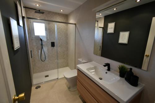 a bathroom with a shower and a sink and a toilet at Villa with separate apartment in Mijas Costa