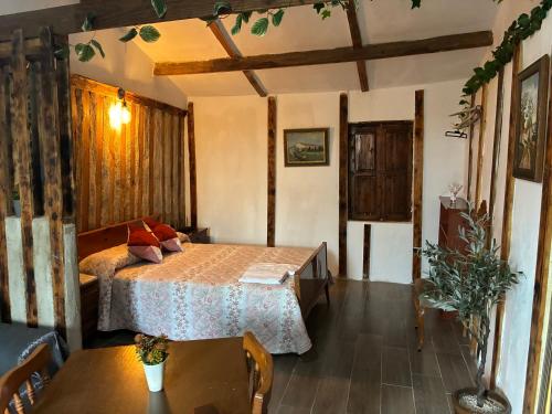 a bedroom with a bed and a table and chairs at Cabaña rural piscina privada in Orihuela