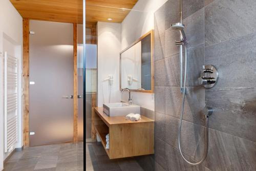 a bathroom with a sink and a shower at Angerle Alm Apt Similde B in Carezza al Lago