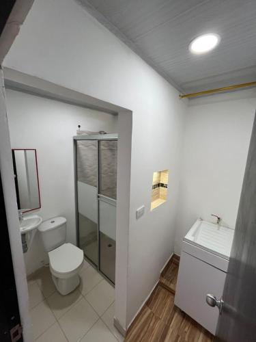 a bathroom with a toilet and a glass shower at 306ApartaesudioRomance in Arauca