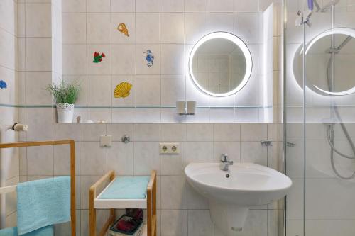 a bathroom with a sink and a shower with a mirror at Preiser in Moos