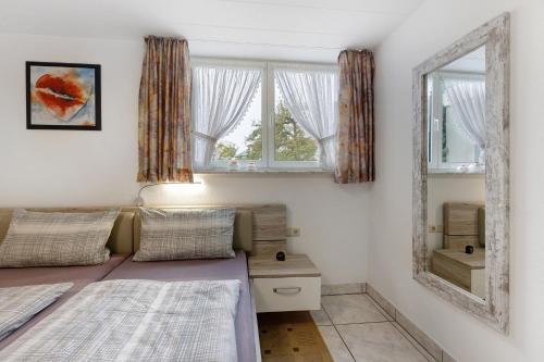 a bedroom with two beds and a mirror at Preiser in Moos