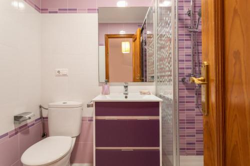 a bathroom with a toilet and a sink and a shower at Casa Pedro Piscina in Puerto Marino
