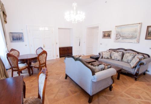 a living room with two couches and a table at Zámek Jeseník Nad Odrou in Jeseník nad Odrou