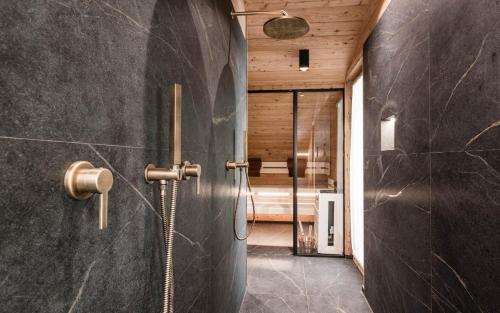a bathroom with a shower and a walk in shower at New Chalet Brunegg Weissenbach in Rio Bianco