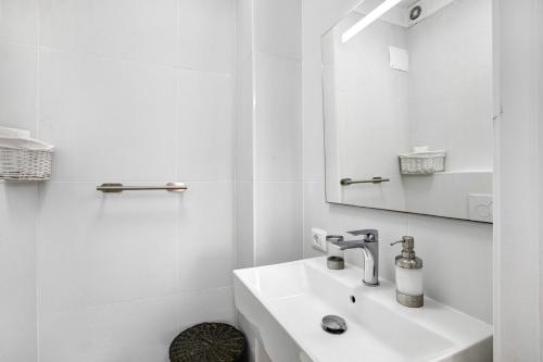 a white bathroom with a sink and a mirror at Bonamar in Arona