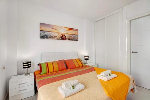 a bedroom with a bed with towels on it at Bonamar in Arona