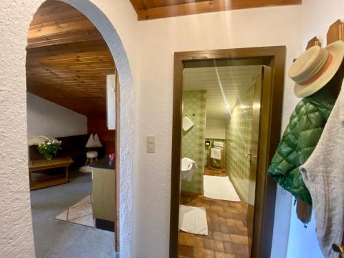 a room with a hallway with a mirror and a bathroom at Wolfbachgut - Ferienwohnung 5 in Taxenbach