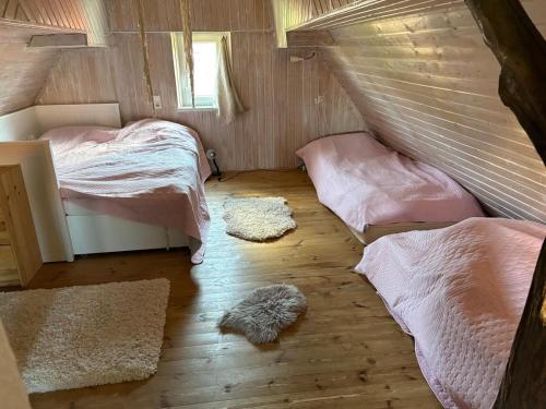 a bedroom with two beds and two rugs at Haus herhönspatziert in Willmars