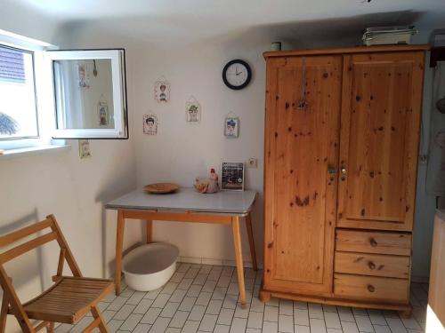 a room with a table and a wooden cabinet at Haus herhönspatziert in Willmars