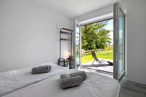 a bedroom with a bed and a sliding glass door at Ferienhaus Ebbe in Schülp