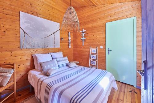 a bedroom with a bed with a bridge picture on the wall at Gite Escale Bien Etre à Biscarrosse in Biscarrosse
