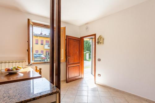 a kitchen with a door leading to a hallway at Enza's Petite Maison in Santa Croce sullʼ Arno
