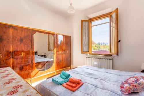 a bedroom with a bed with a large mirror at Enza's Petite Maison in Santa Croce sullʼ Arno