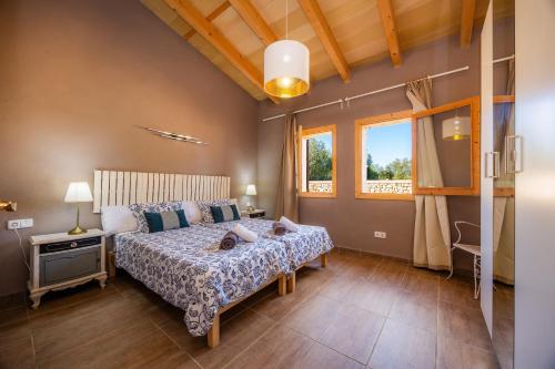 a bedroom with a bed with two people on it at Finca Ca S'Hereu Mas in Campos