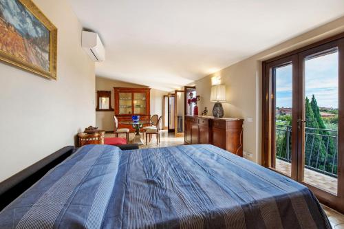 a bedroom with a large bed and a balcony at Casa Solarolo in Montinelle