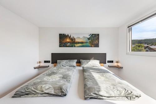 a bedroom with two beds and a window at Auszeit Matzi in Öhningen