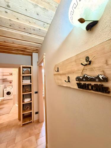 a room with a surfboard on the wall at Casa Clus Bormio apartments 3 in Valdisotto