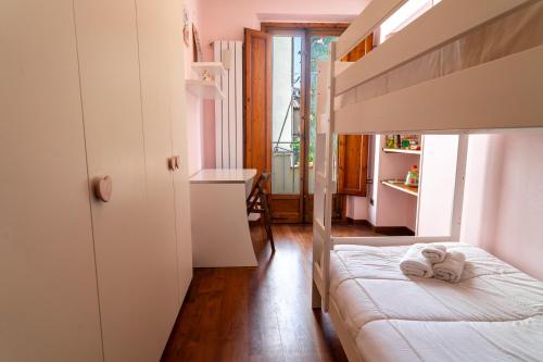 a small bedroom with a bed and a window at Barsotti House - Lucca in Lucca
