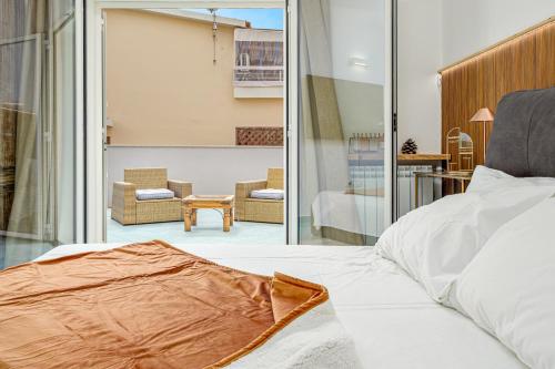a bedroom with a bed and a living room at Colombo Apartment - by And Service in Golfo Aranci