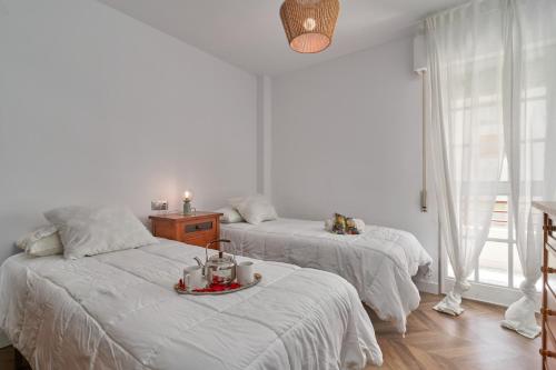 a bedroom with two beds with a tray of food on it at La Mejor in Torrox