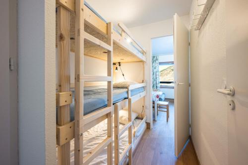 a room with two bunk beds and a hallway at Appartement Les Menuires in Les Menuires