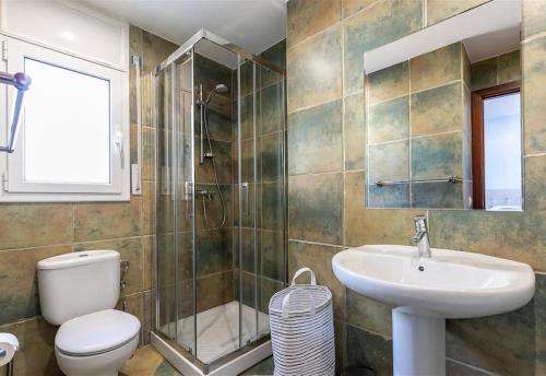 a bathroom with a toilet and a sink and a shower at Casa Nuestra in Begur