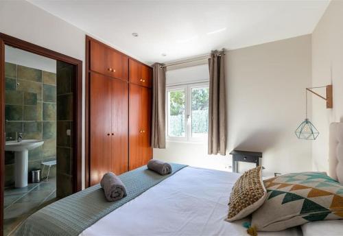 a bedroom with a large bed and a bathroom at Casa Nuestra in Begur