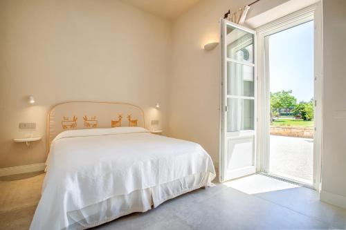 a bedroom with a bed and an open door at Dimora Sella Rooms in Alghero