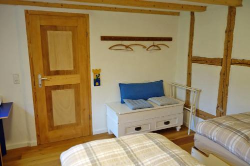 a bedroom with a bed and a door and a drawer at Ferienwohnung Teich 11, 126qm in Gütenbach