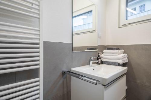 a bathroom with a sink and a mirror at Ferienwohnung Montfort in Langenargen