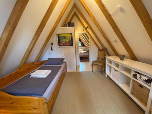 a bedroom with a bed in a attic at Charmantes Ferienhaus mit Garten in Siegsdorf