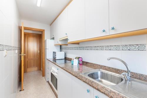 a kitchen with a sink and a counter top at Mistral Apartment La Manga in San Javier